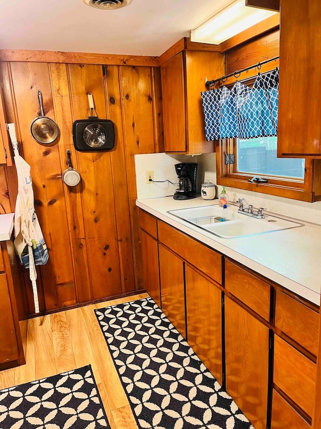 kitchen with sink and light hardwood / wood-style floors