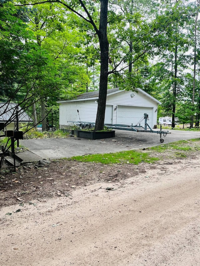 view of property exterior featuring a garage and an outdoor structure