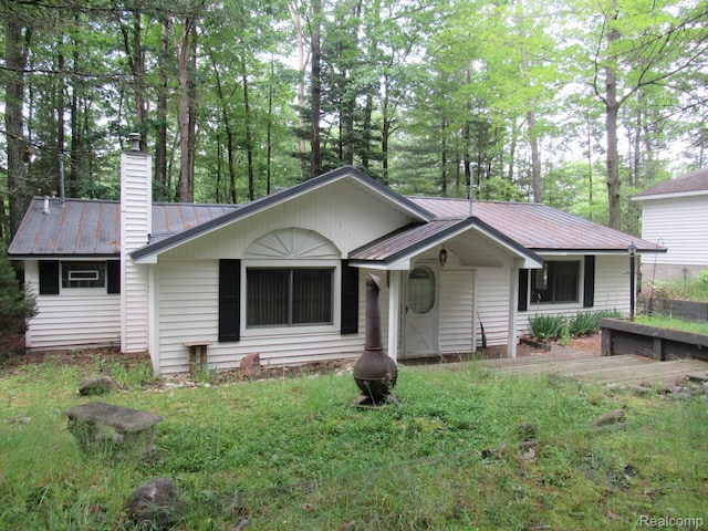 432 Chickasaw St, Roscommon, MI 48653 - single story home featuring a chimney and a metal roof