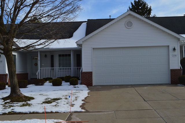 ranch-style house with a garage and covered porch