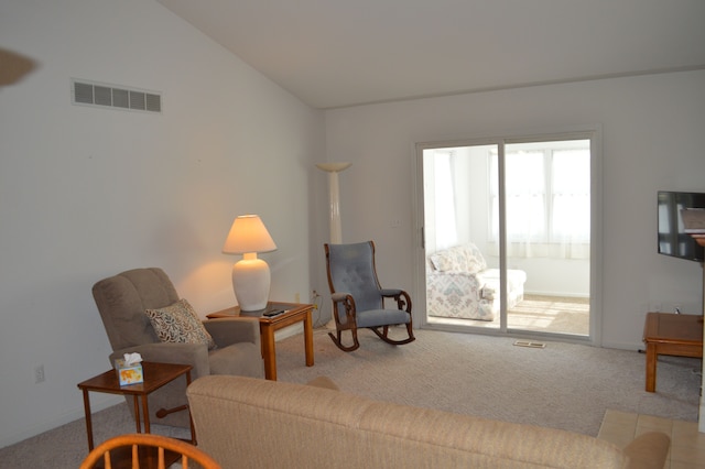 living room featuring light carpet and lofted ceiling