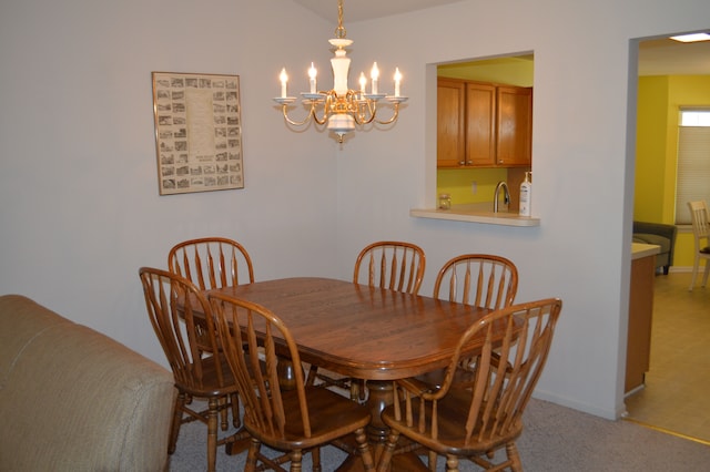 dining room with light colored carpet, a chandelier, and sink