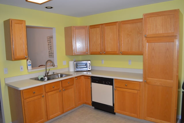 kitchen featuring white dishwasher and sink