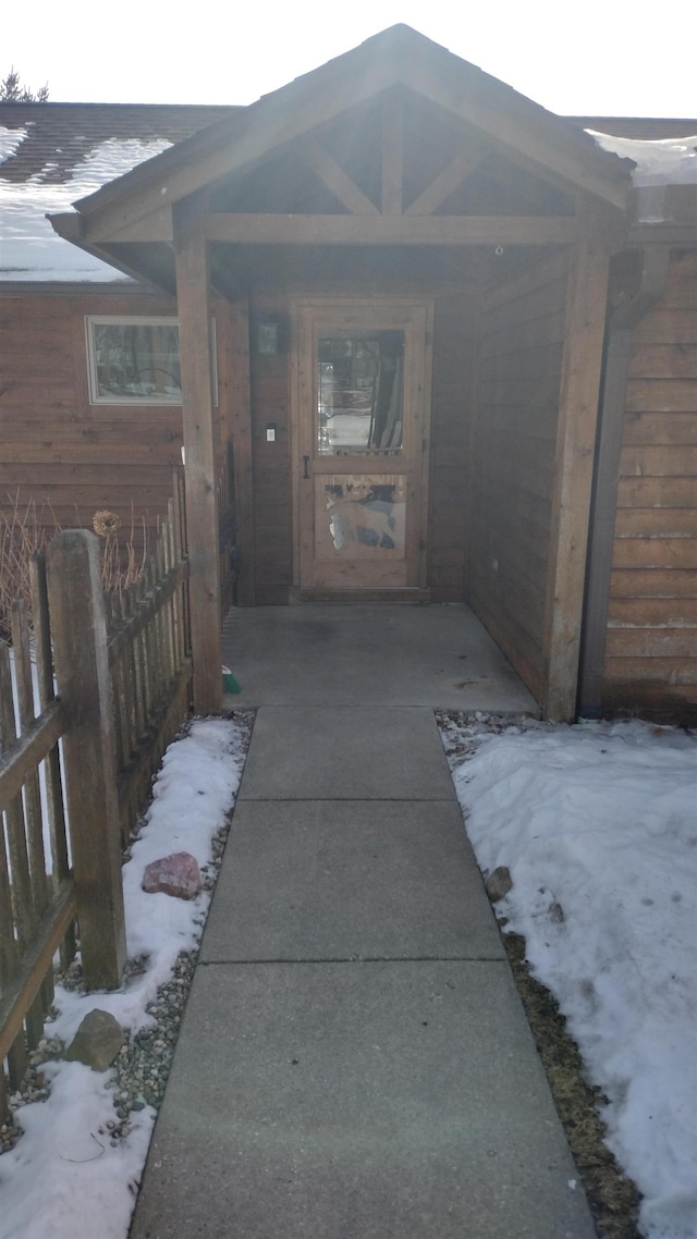 view of snow covered property entrance