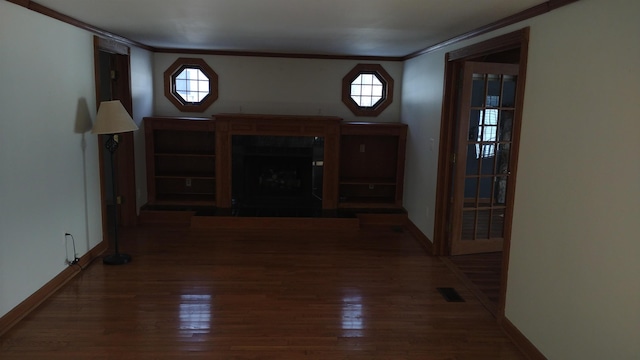 entrance foyer featuring dark hardwood / wood-style flooring, plenty of natural light, and ornamental molding