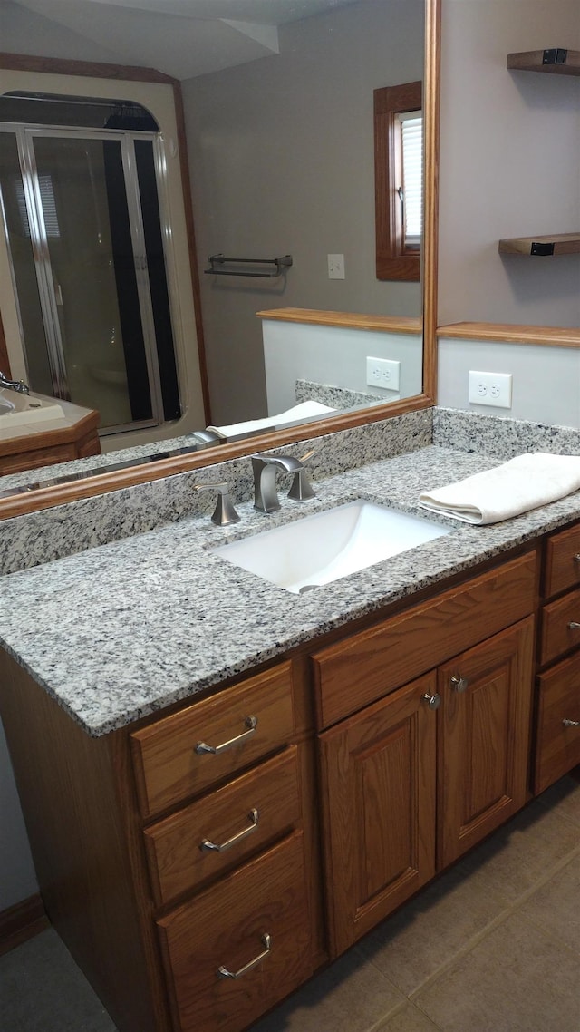 bathroom with vanity and a shower with shower door