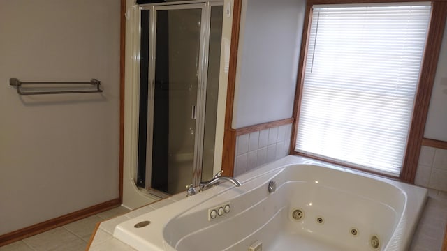 bathroom with tile patterned floors and independent shower and bath