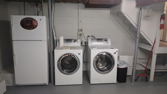 clothes washing area with independent washer and dryer