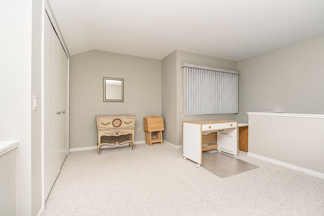 carpeted office with vaulted ceiling