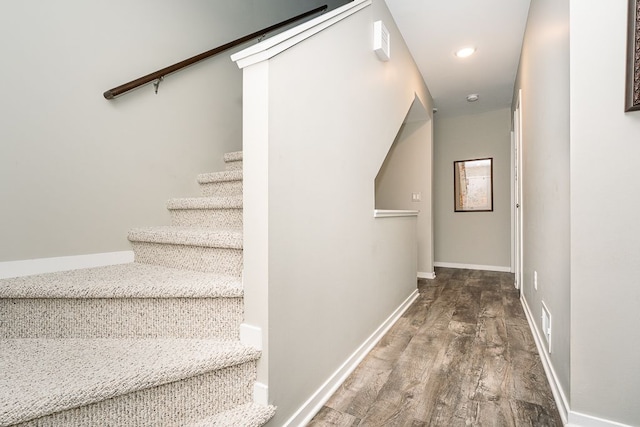 stairway with hardwood / wood-style floors