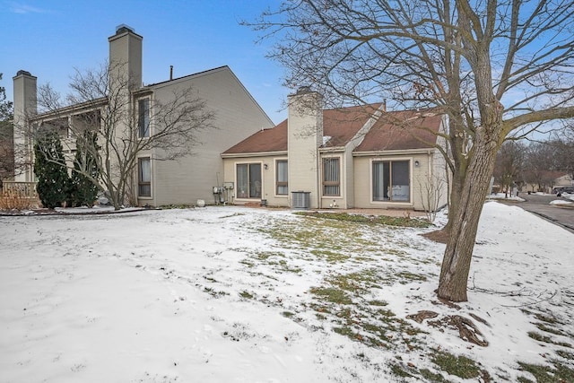 snow covered house with cooling unit