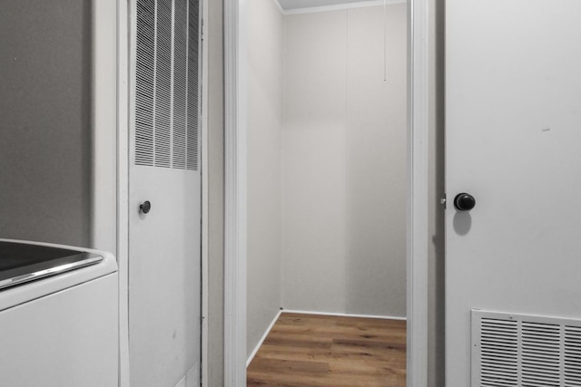 laundry area with hardwood / wood-style floors