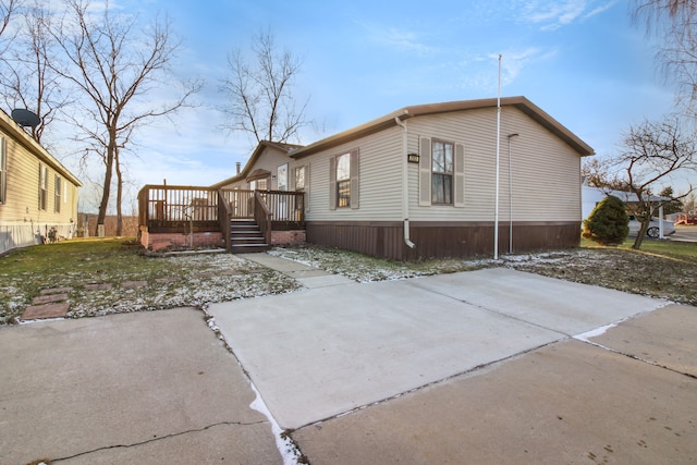 view of home's exterior with a patio and a deck