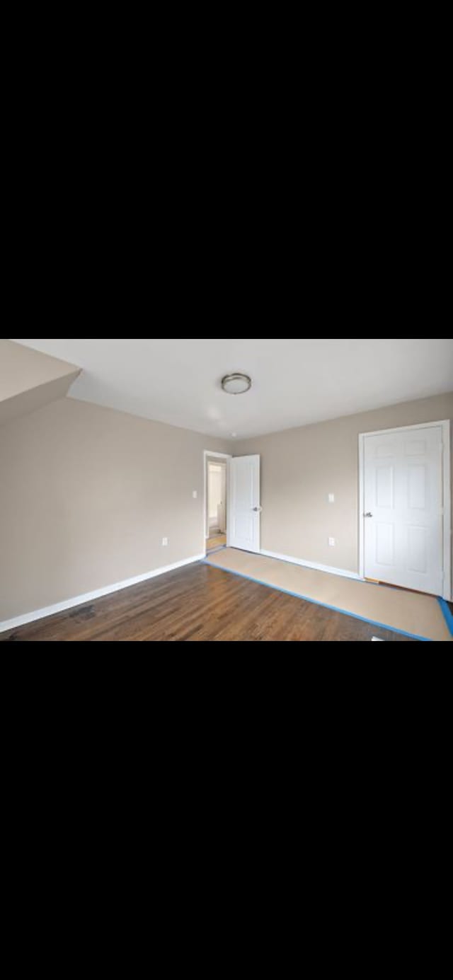 empty room with hardwood / wood-style flooring