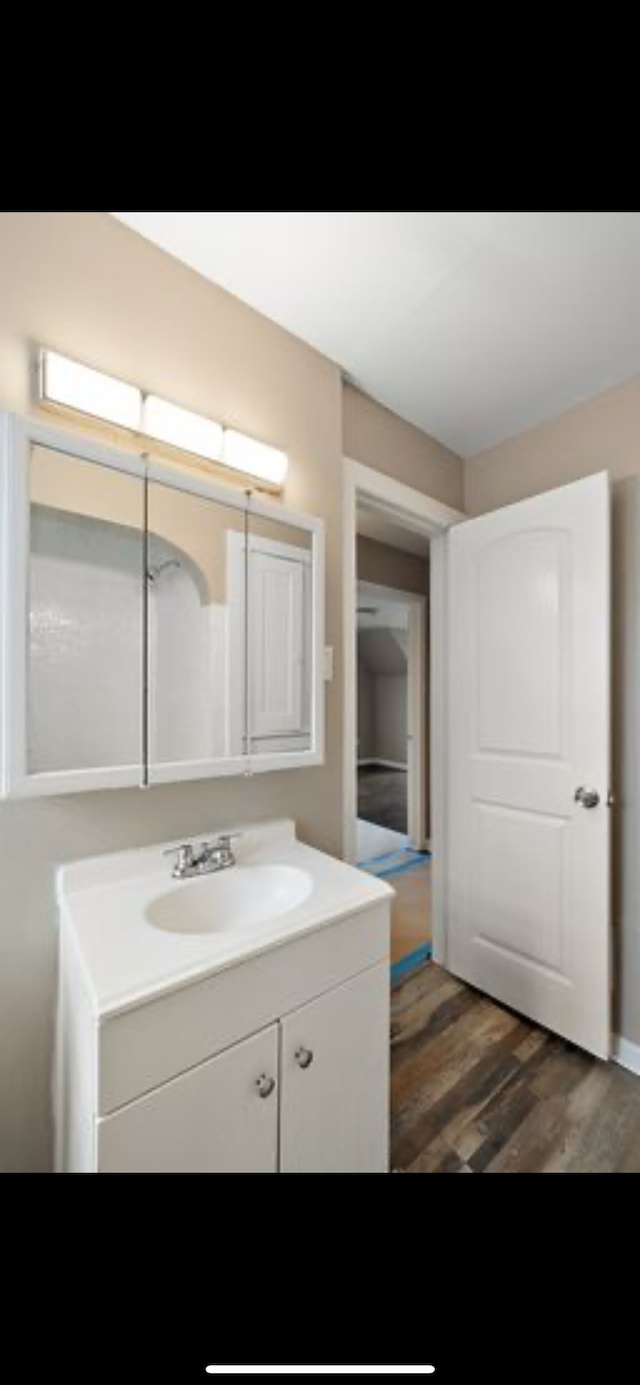 bathroom featuring vanity and hardwood / wood-style floors