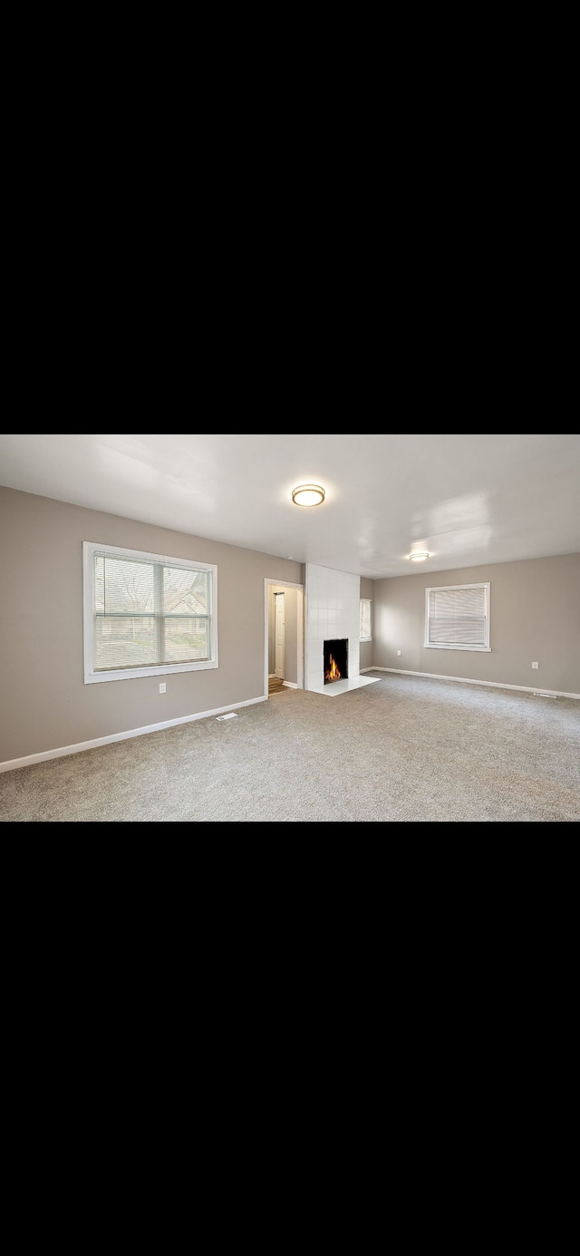 unfurnished living room featuring carpet