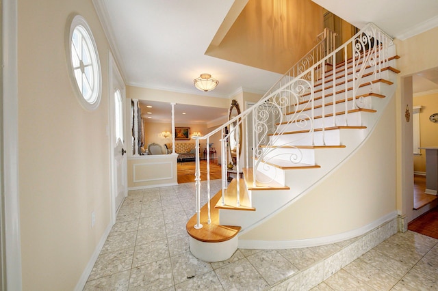 stairs featuring crown molding