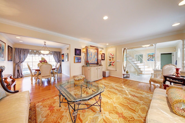 living room with ornamental molding and hardwood / wood-style floors