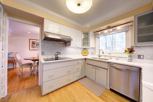 kitchen featuring dishwasher, black electric cooktop, sink, and crown molding