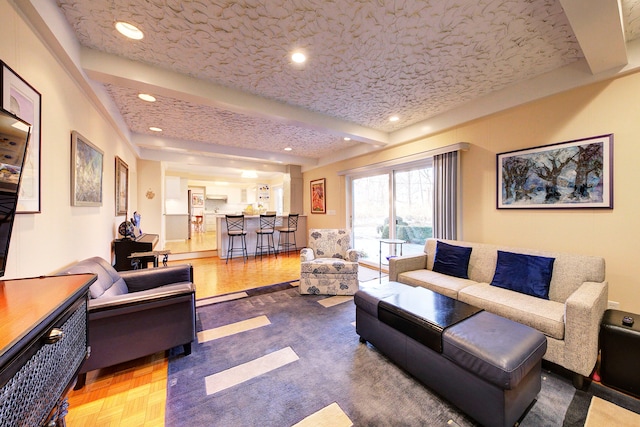 living room with parquet floors and beam ceiling