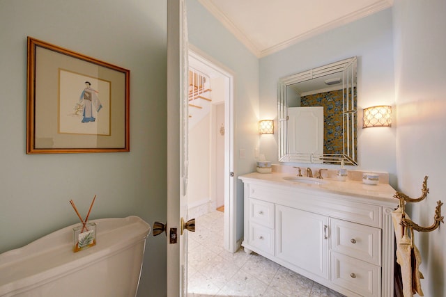 bathroom with vanity, ornamental molding, and toilet