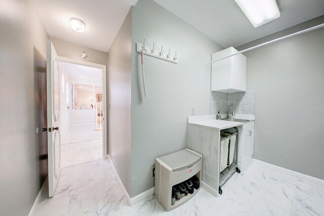 bathroom with tasteful backsplash and sink