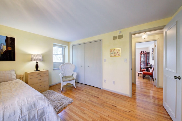 bedroom featuring light hardwood / wood-style floors and a closet