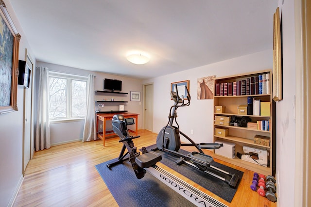 exercise room with hardwood / wood-style flooring