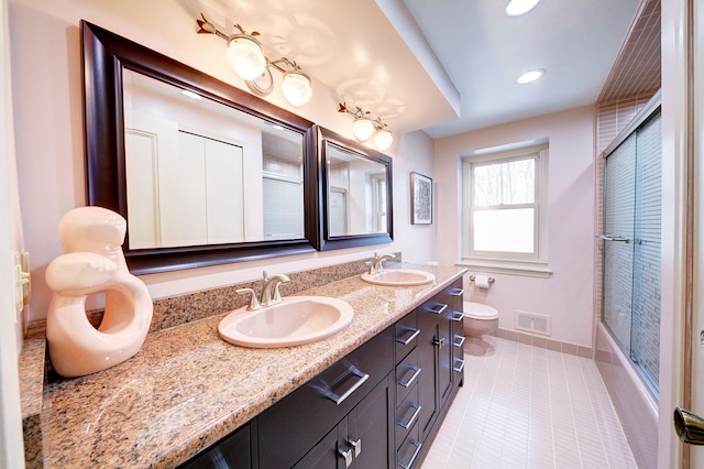 full bathroom featuring enclosed tub / shower combo, vanity, toilet, and tile patterned floors