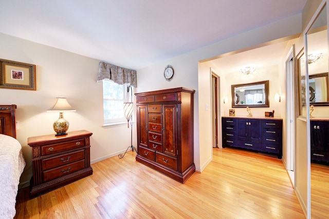 bedroom featuring sink and light hardwood / wood-style floors