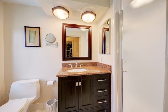 bathroom featuring vanity and toilet