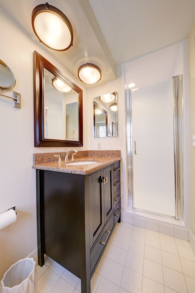 bathroom with vanity, tile patterned floors, and walk in shower