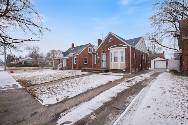 bungalow-style house with a garage and an outdoor structure