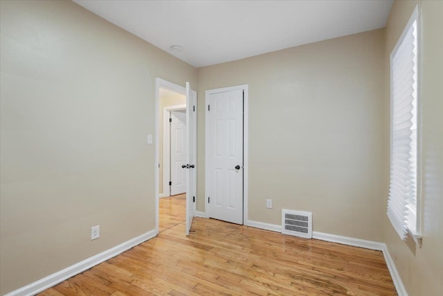 unfurnished room with light hardwood / wood-style floors