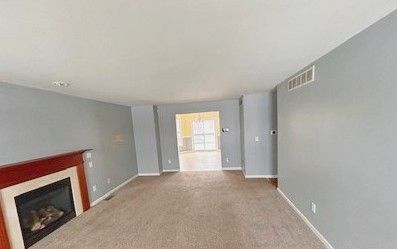 unfurnished living room with carpet flooring