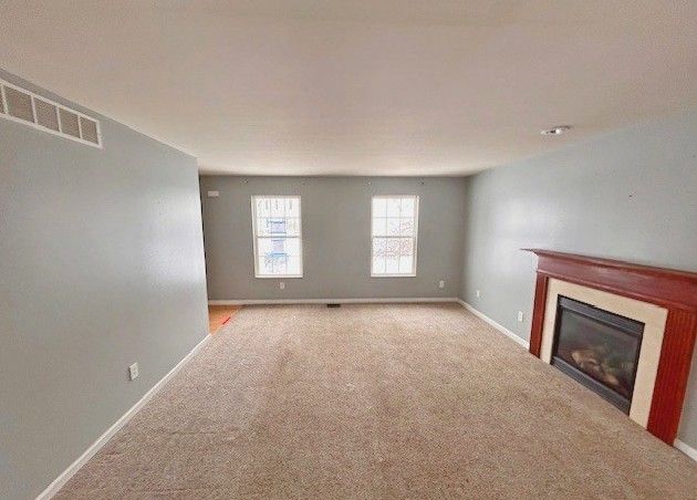 unfurnished living room with light carpet