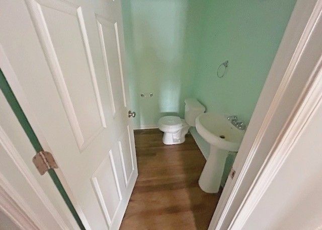 bathroom with toilet and hardwood / wood-style floors