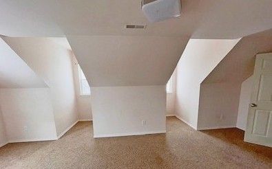 additional living space with vaulted ceiling