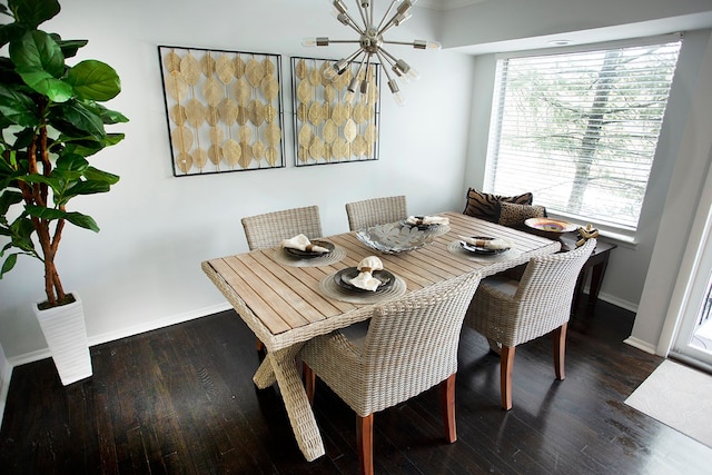 dining space featuring dark hardwood / wood-style floors and an inviting chandelier