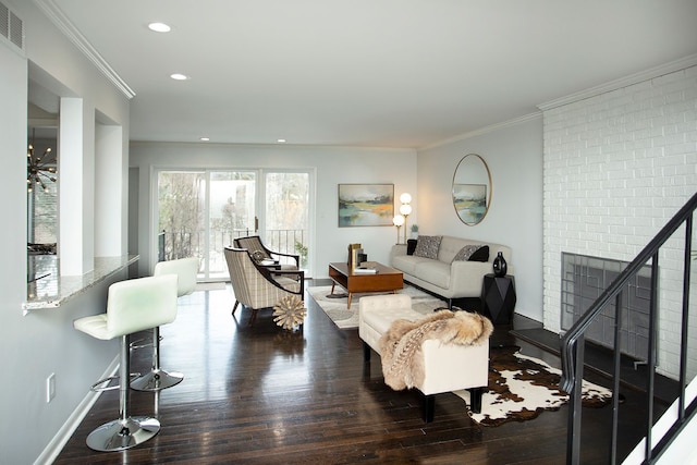 living room with ornamental molding and dark wood-type flooring