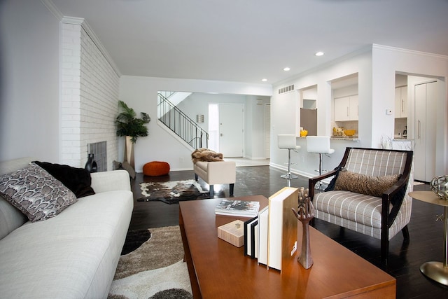 living room with ornamental molding and dark hardwood / wood-style flooring