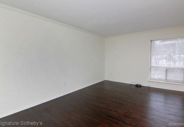 empty room featuring crown molding and dark hardwood / wood-style floors