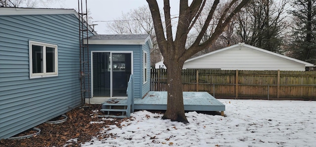 yard covered in snow featuring a deck