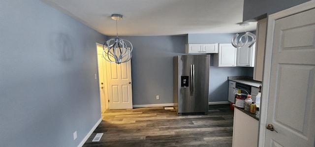 kitchen with dark hardwood / wood-style floors, pendant lighting, white cabinets, and stainless steel fridge with ice dispenser