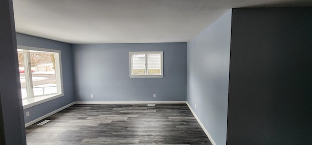 empty room with dark wood-type flooring