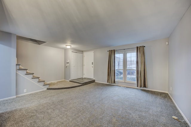 unfurnished living room featuring carpet flooring