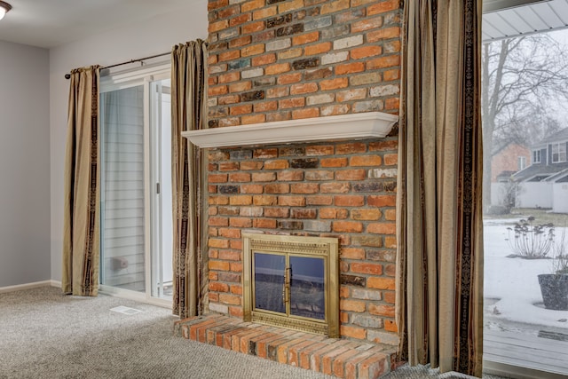 interior details featuring a fireplace and carpet