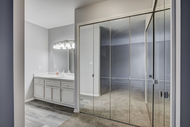 bathroom with vanity and hardwood / wood-style floors