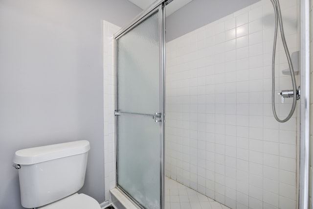 bathroom with an enclosed shower and toilet