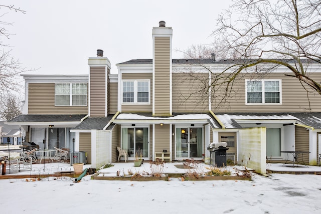 snow covered house featuring a wooden deck